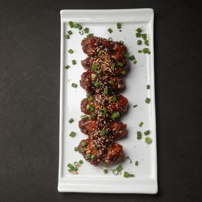 Xin Asian Chicken Wings — twice-fried, glazed with soy-honey and toasted sesame, served with pickled slaw