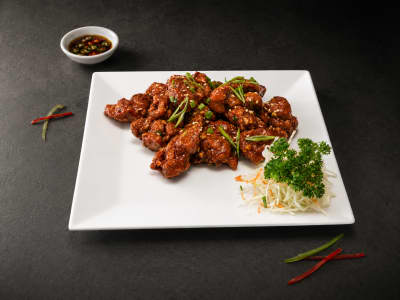 Xin Korean Fried Chicken — double-fried chicken thigh in gochujang-honey glaze with sesame and scallion