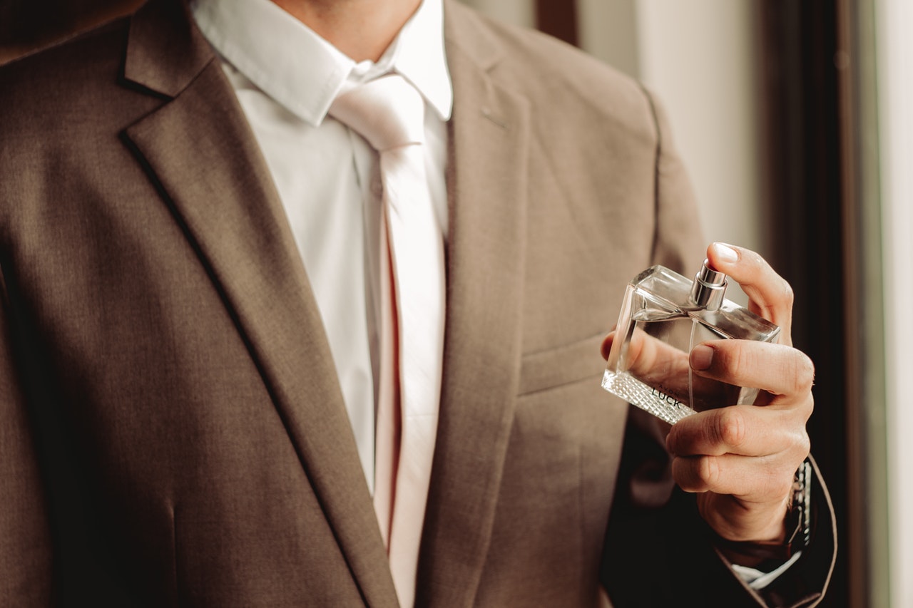 Man holding perfume bottle