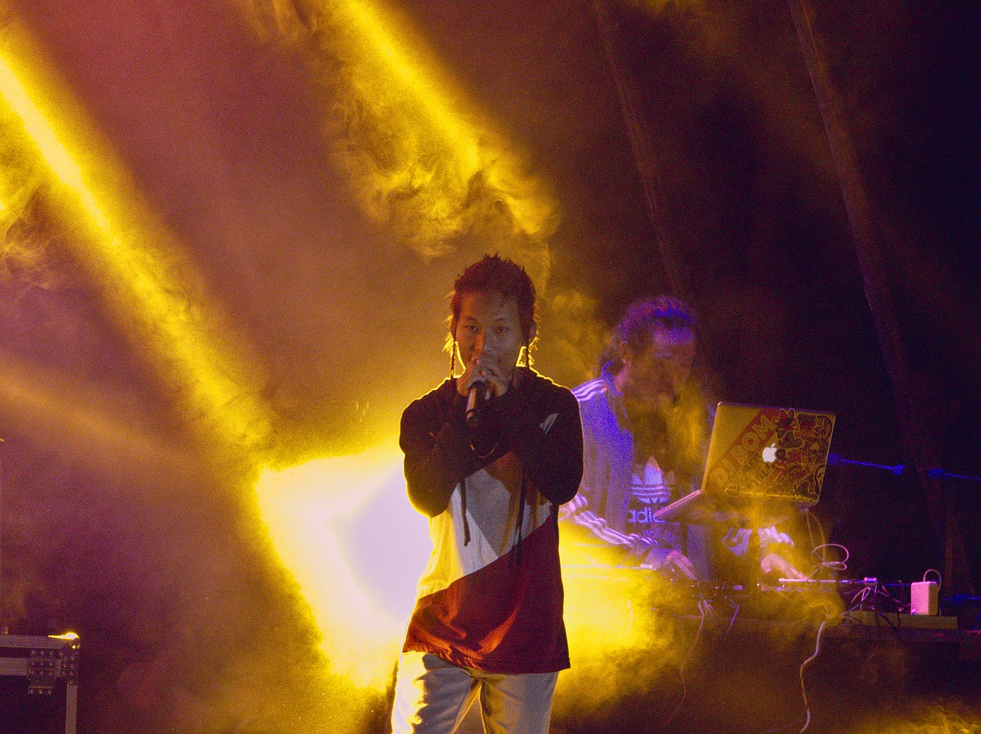 Artist performing under yellow lights