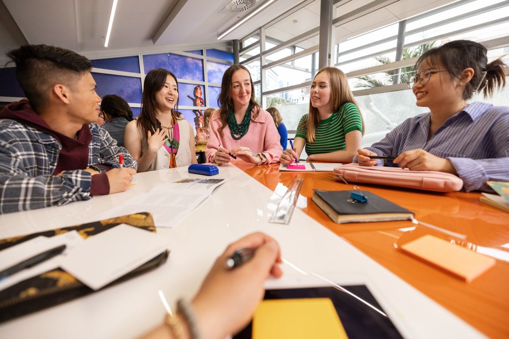 Group of students working around a table. 