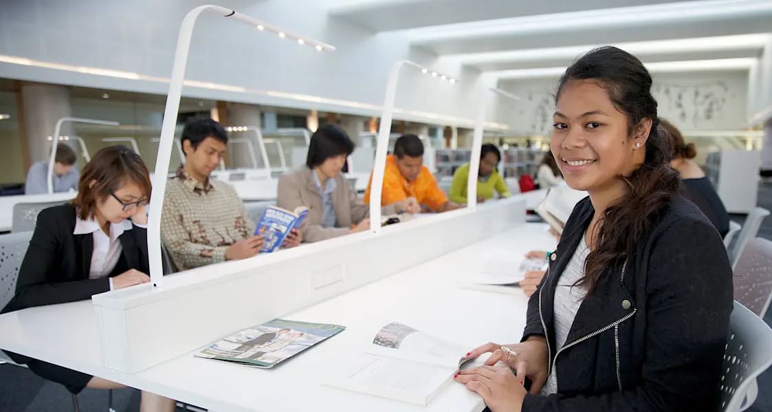 Group of students working at a desk.