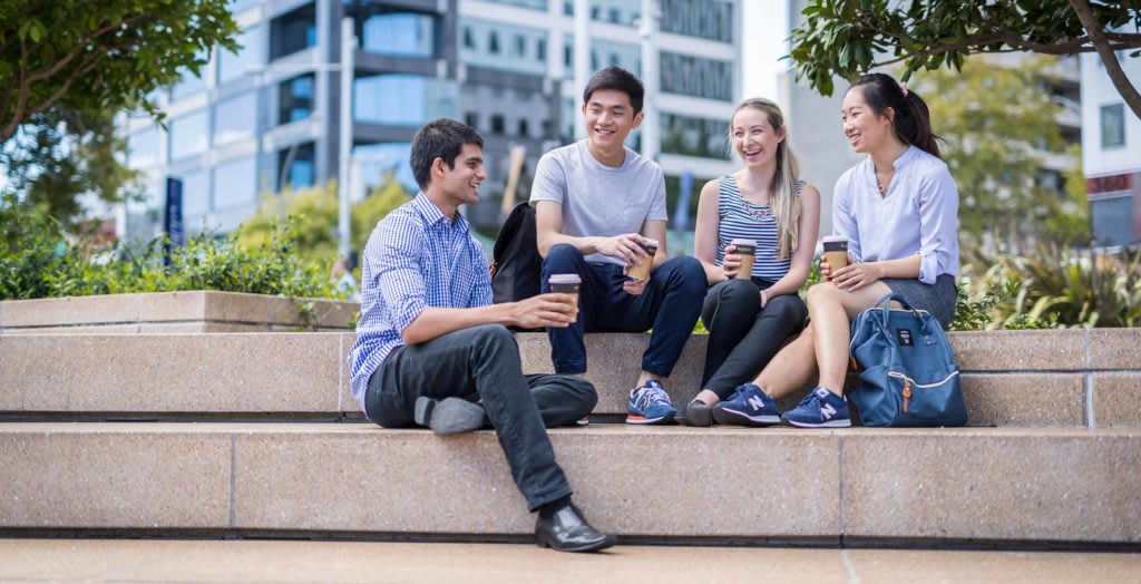 Group of students sitting on steps.