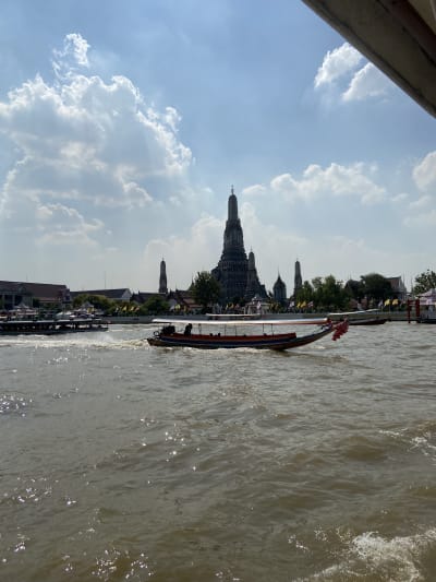 Wat Arun spires against blue sky