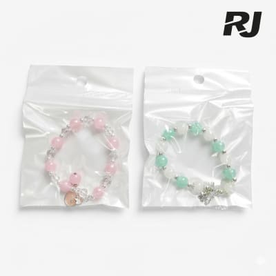 Pulsera de perlas transp c/adorno p/ninos