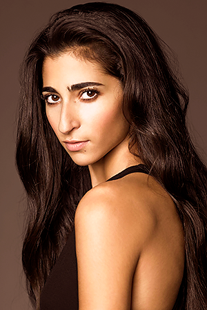picture of Alba Flores, a Spanish actress. She has long dark brown hair, light brown skin, thick eyebrows, big dark eyes, and a prominent nose.