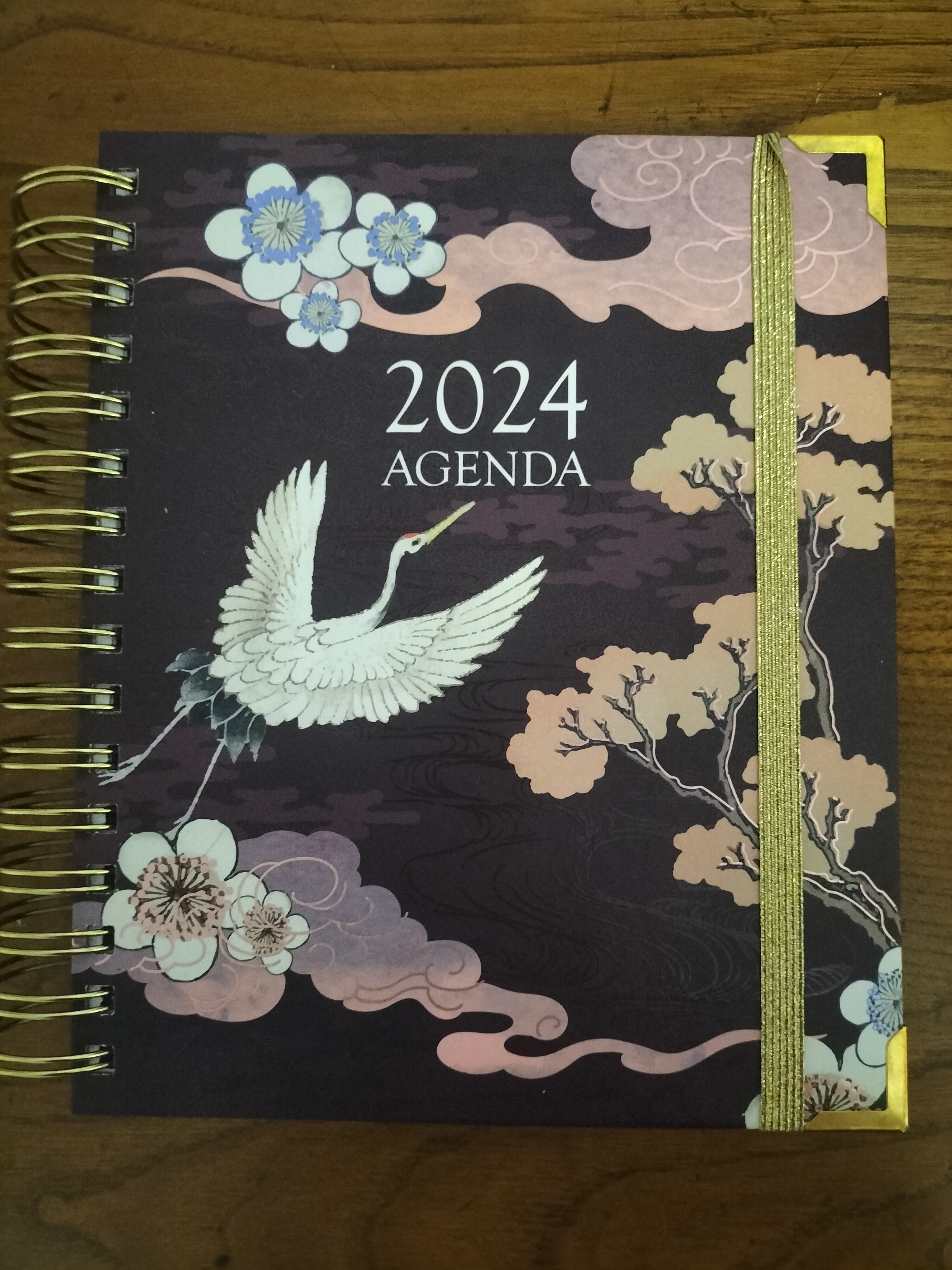 Picture of a 2024 planner with drawings of cranes in flight, flowers and trees.