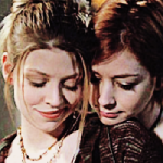 Tara smiles as Willow hugs her from behind, resting her chin on Tara's shoulder.