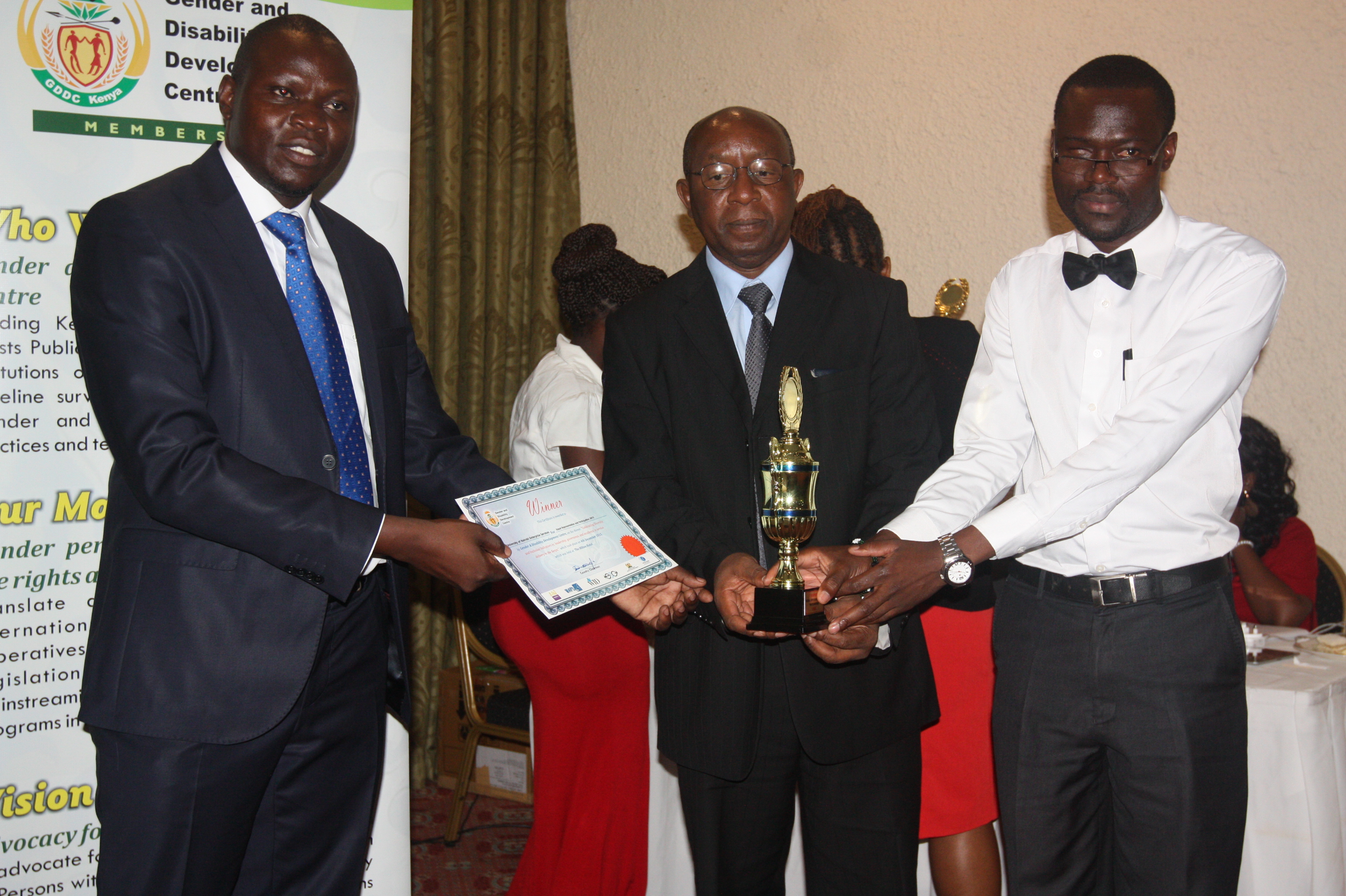 Richard Issuing an Award to UoN for 1st Runners Up Performance in Mainstreaming Gender in Academia