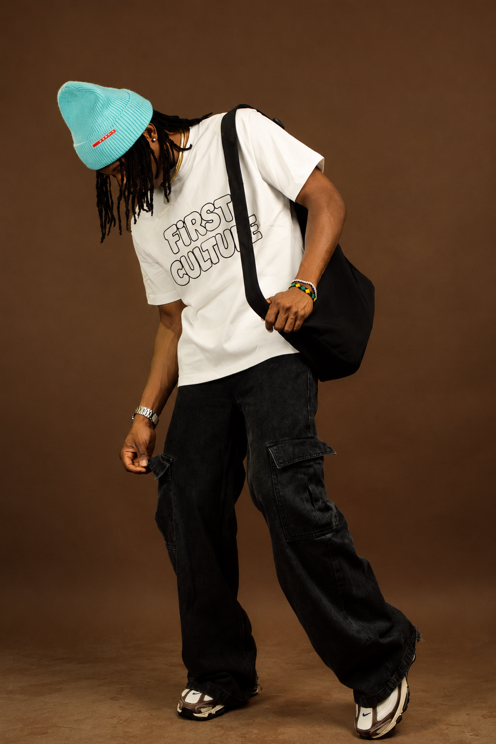 FIRST CULTURE streetwear — model in baggy track pants