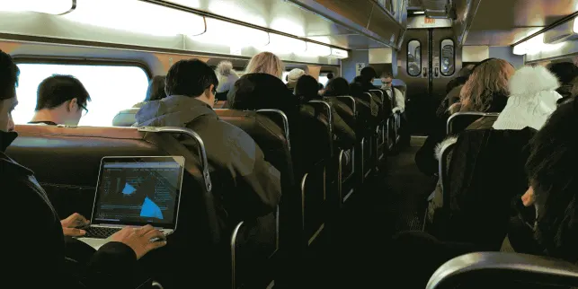 a person working on their laptop on a bus