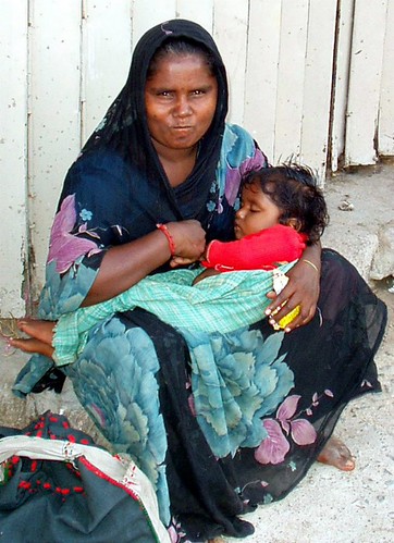 Indian mother picking up garbage