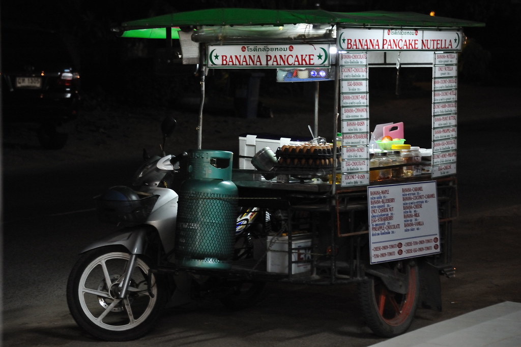 Indian street vendor serving pancakes