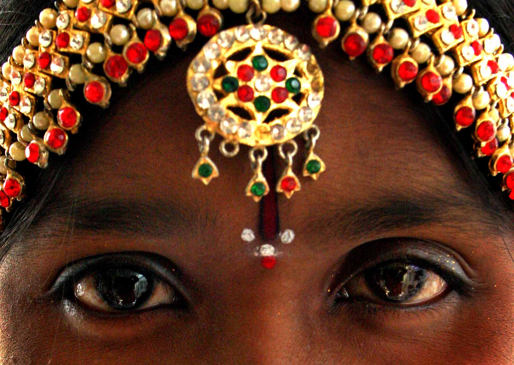 close-up gold jewellery on dancers