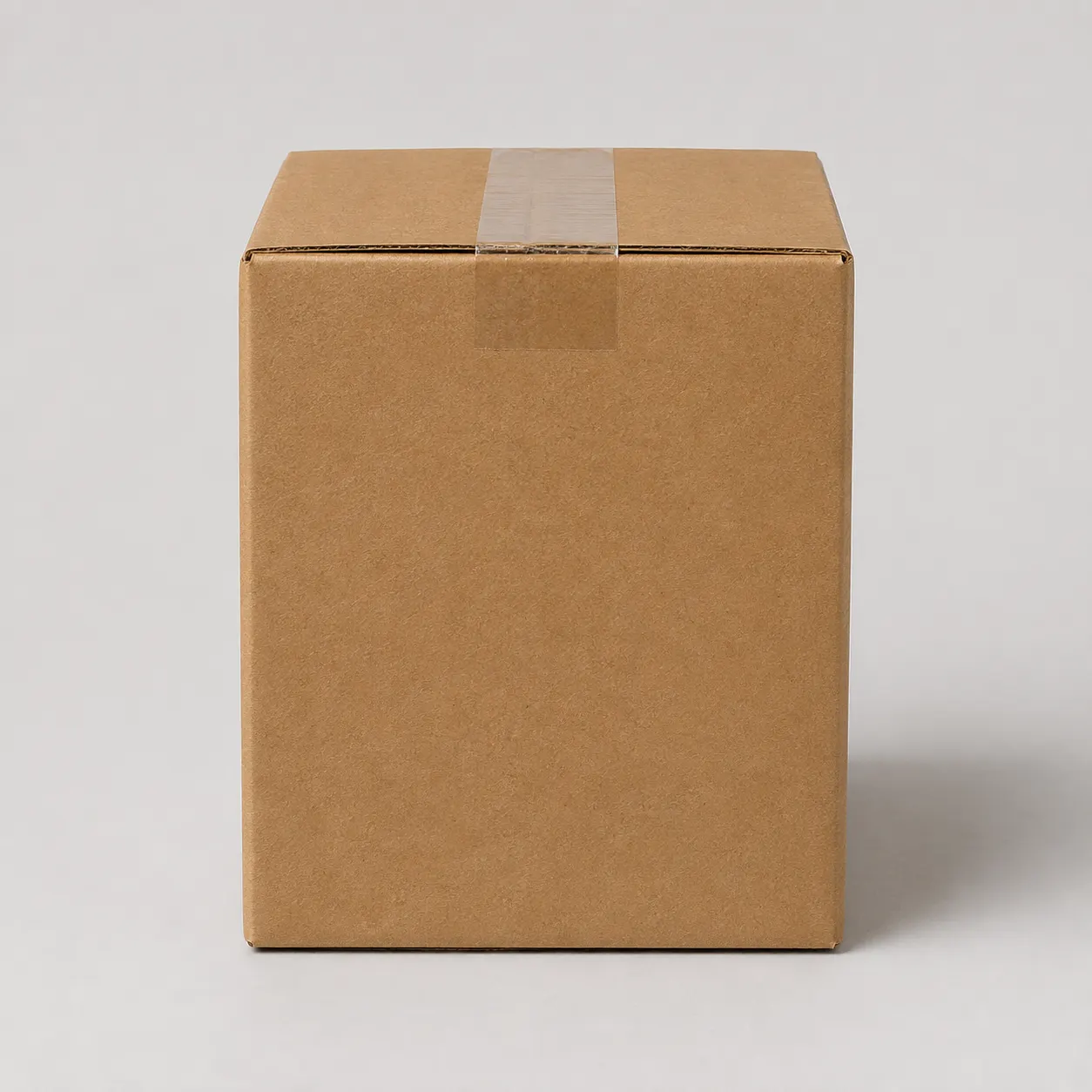 Close-up view of brown corrugated carton material and tape area