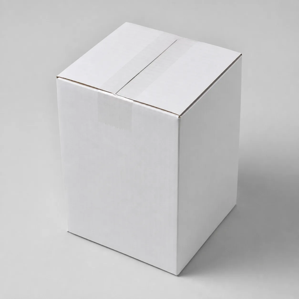 Close-up view of white corrugated carton material and tape area