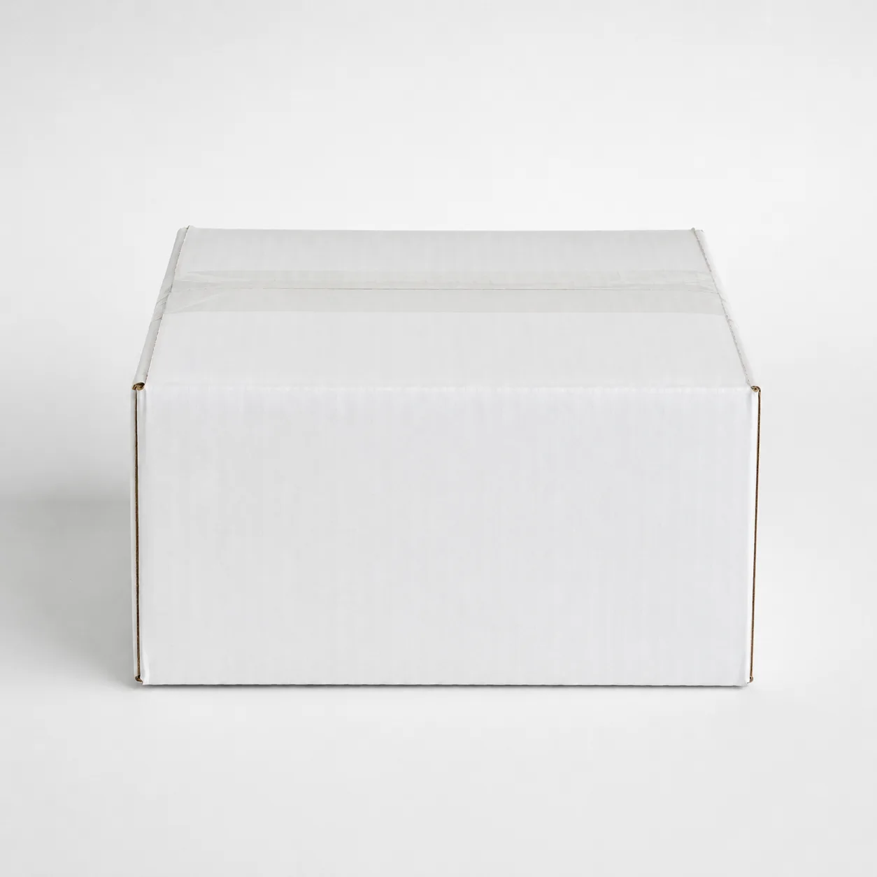 Front angle view of 5x5x2.75 inch white taped corrugated carton box
