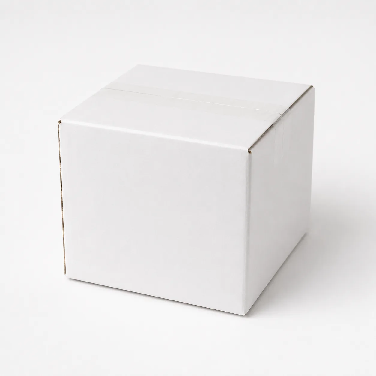 Close-up view of white corrugated carton material and tape area