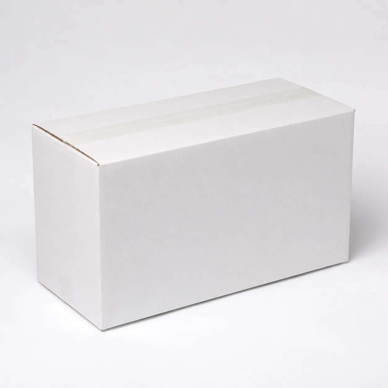 Close-up view of white corrugated carton material and tape area