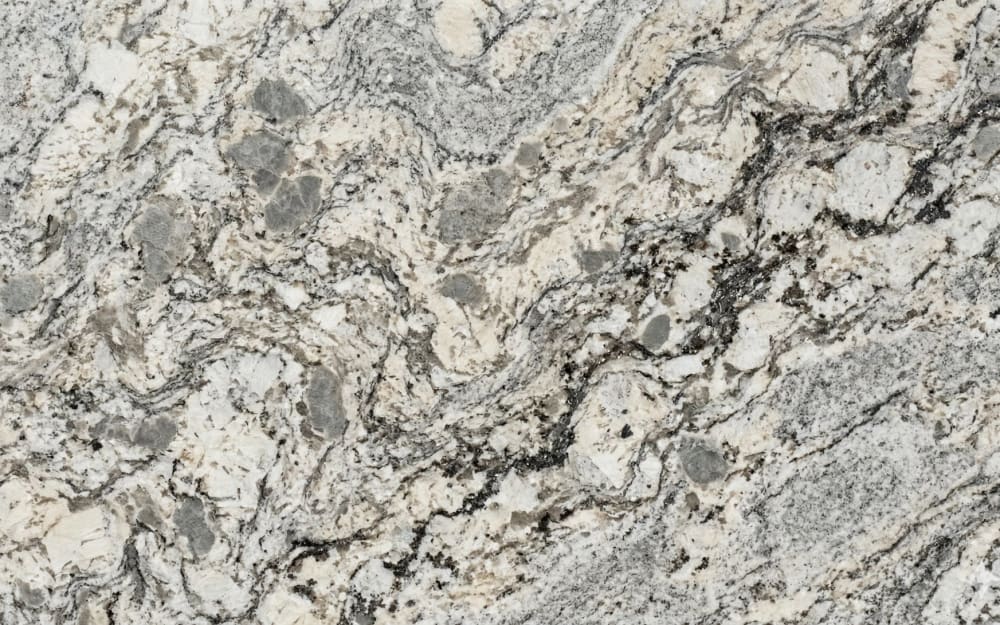 Andino White granite — polished slab surface showing White coloring. Origin: Brazil. Hardness: 6 Mohs. Acid sensitivity: none.