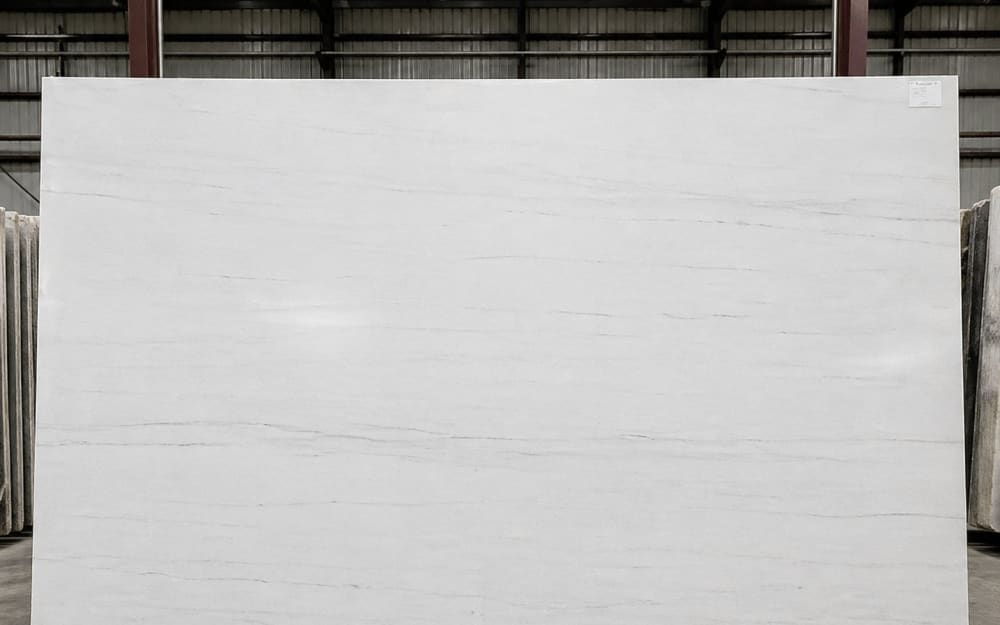 Bianco Dolomiti dolomite — polished slab surface showing White coloring. Origin: Italy (Dolomite Mountains). Hardness: 3.5 Mohs. Acid sensitivity: medium.