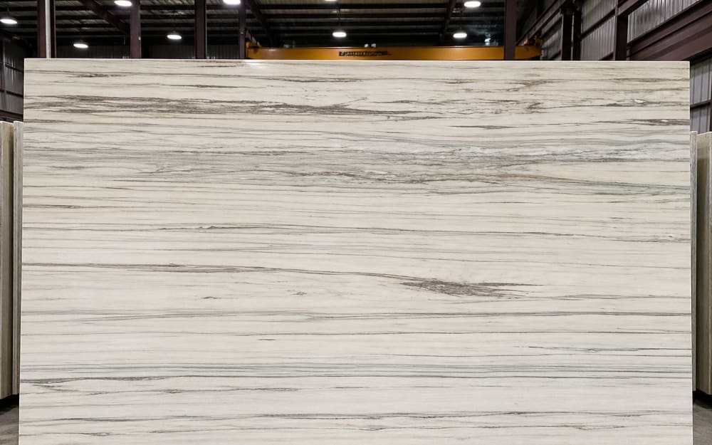 Bianco Ibiza marble — polished slab surface showing White coloring. Origin: Spain / Turkey. Hardness: 3 Mohs. Acid sensitivity: high.