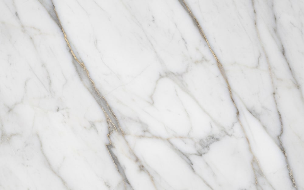 Calacatta Berrini marble — polished slab surface showing White coloring. Origin: Brazil. Hardness: 3 Mohs. Acid sensitivity: high.