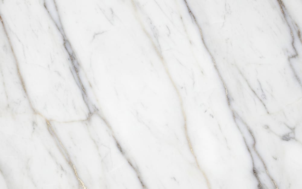 Calacatta Camouflage marble — polished slab surface showing White coloring. Origin: Italy (Carrara). Hardness: 3 Mohs. Acid sensitivity: high.