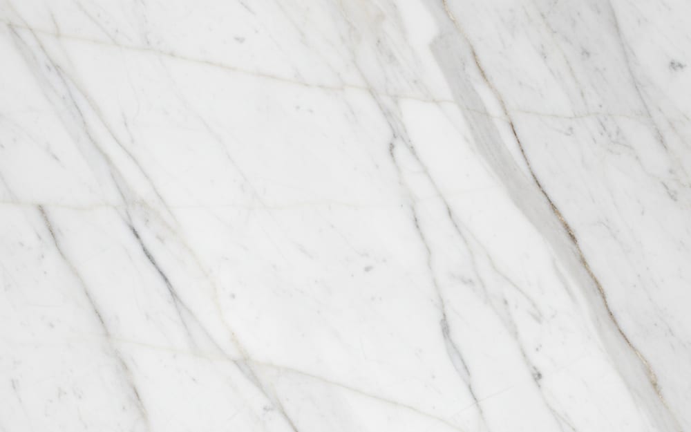 Calacatta Corchia marble — polished slab surface showing White coloring. Origin: Italy (Apuan Alps — Corchia). Hardness: 3 Mohs. Acid sensitivity: high.