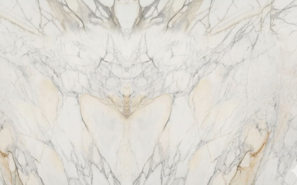 Calacatta Michelangelo marble — polished slab surface showing White coloring. Origin: Italy (Carrara). Hardness: 3 Mohs. Acid sensitivity: high.