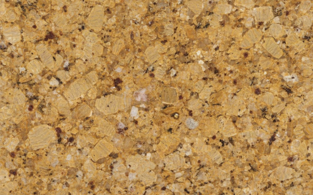 Caramel Gold granite — polished slab surface showing Gold/Yellow coloring. Origin: India. Hardness: 6 Mohs. Acid sensitivity: none.