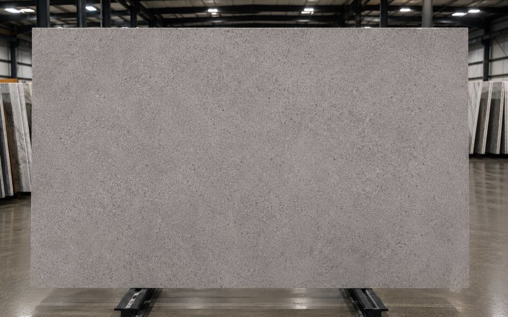 Cèdre Gris limestone — polished slab surface showing Cream coloring. Origin: Morocco. Hardness: 3 Mohs. Acid sensitivity: high.