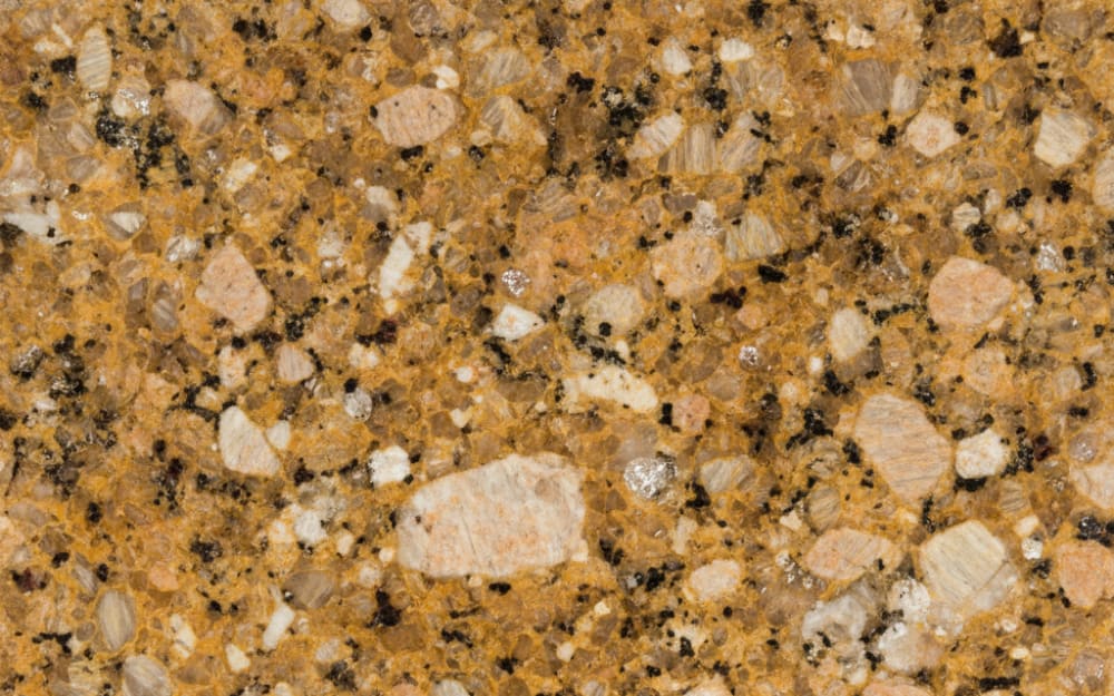 Cosmic Gold granite — polished slab surface showing Gold/Yellow coloring. Origin: Brazil. Hardness: 6 Mohs. Acid sensitivity: none.