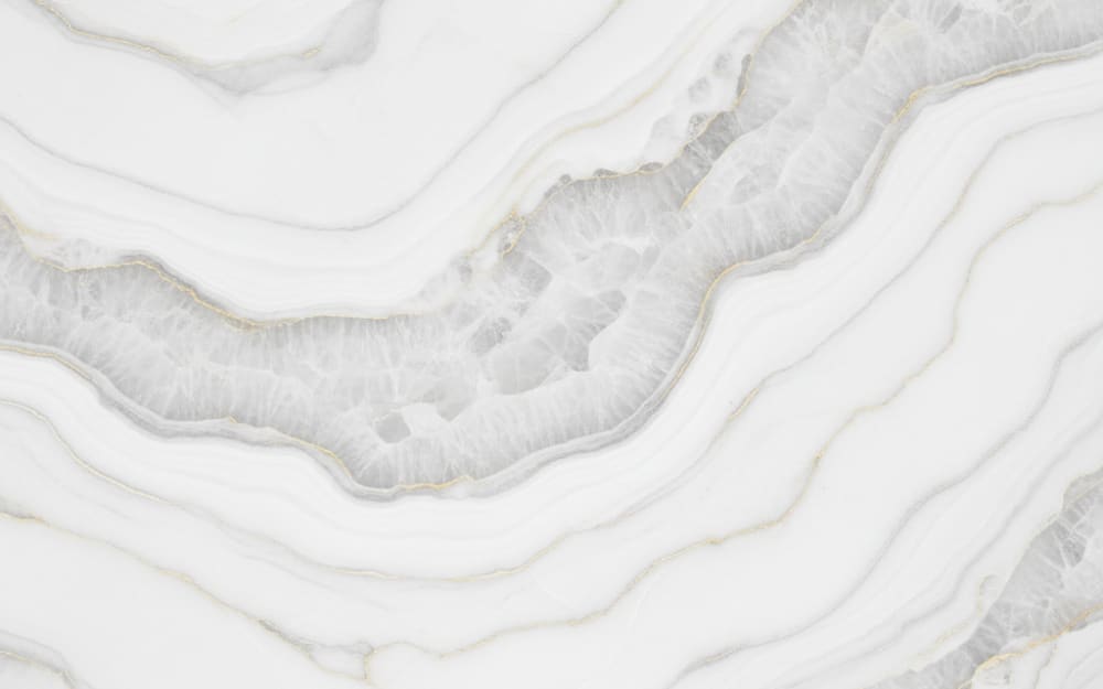 Cristallo quartzite — polished slab surface showing White coloring. Origin: Brazil. Hardness: 7 Mohs. Acid sensitivity: none.