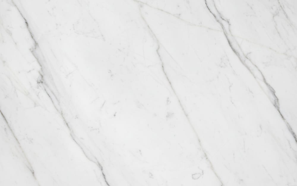 Crystalita White marble — polished slab surface showing White coloring. Origin: Brazil. Hardness: 3 Mohs. Acid sensitivity: high.