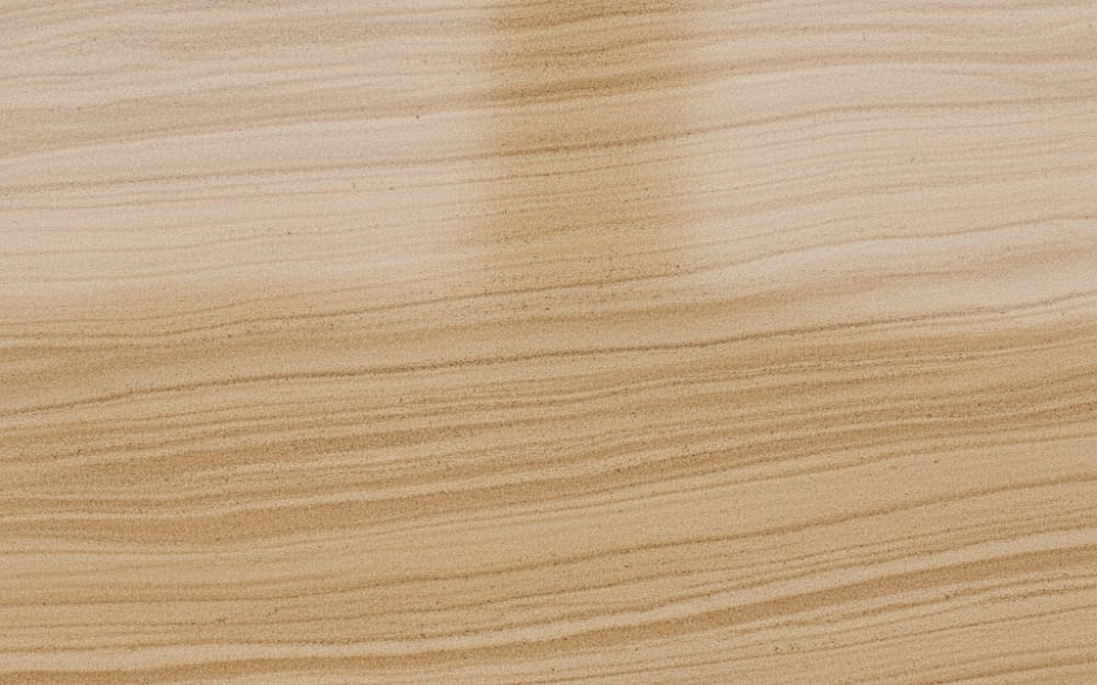 Dholpur Beige Sandstone sandstone — polished slab surface showing Cream coloring. Origin: India (Rajasthan). Hardness: 6 Mohs. Acid sensitivity: none.