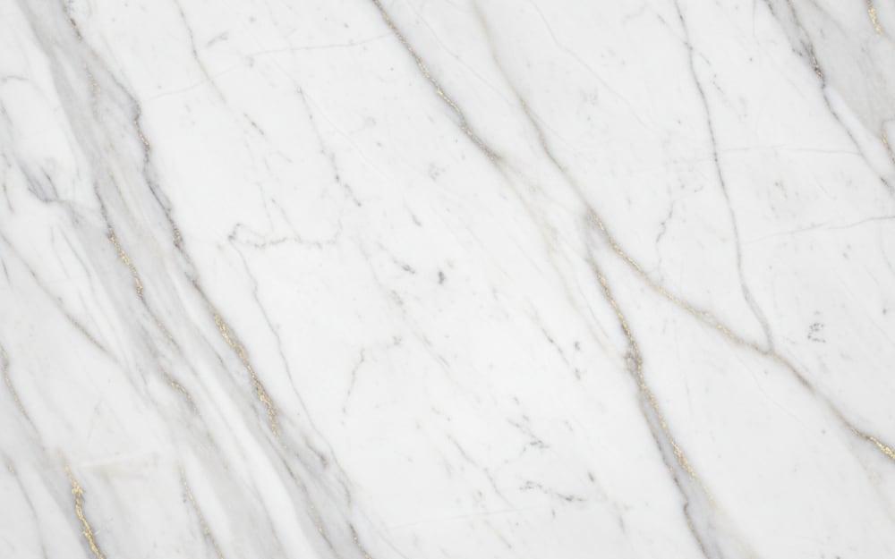 Drama White marble — polished slab surface showing White coloring. Origin: Greece (Drama). Hardness: 3 Mohs. Acid sensitivity: high.