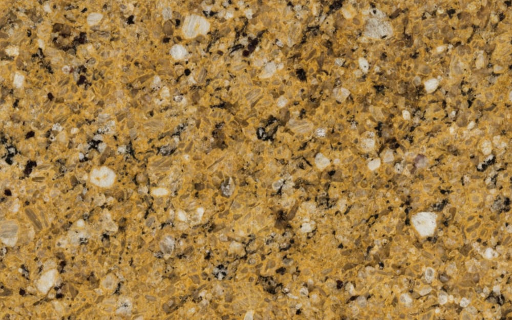 Fusion Gold granite — polished slab surface showing Gold/Yellow coloring. Origin: Brazil. Hardness: 6 Mohs. Acid sensitivity: none.