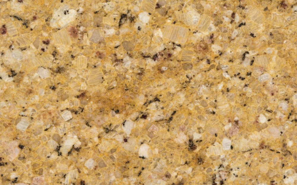 Golden Beach granite — polished slab surface showing Gold/Yellow coloring. Origin: Brazil. Hardness: 6 Mohs. Acid sensitivity: none.