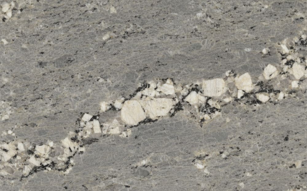 Gran Valle granite — polished slab surface showing Grey coloring. Origin: Brazil. Hardness: 6 Mohs. Acid sensitivity: none.