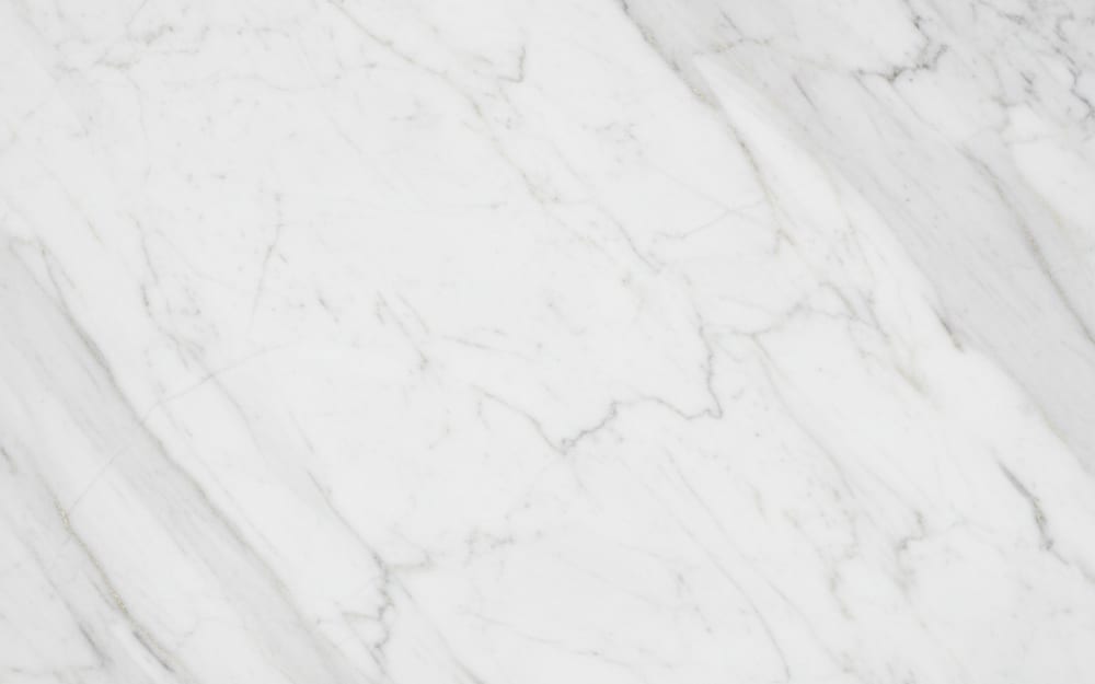 Guangxi White marble — polished slab surface showing White coloring. Origin: China (Guangxi). Hardness: 3 Mohs. Acid sensitivity: high.