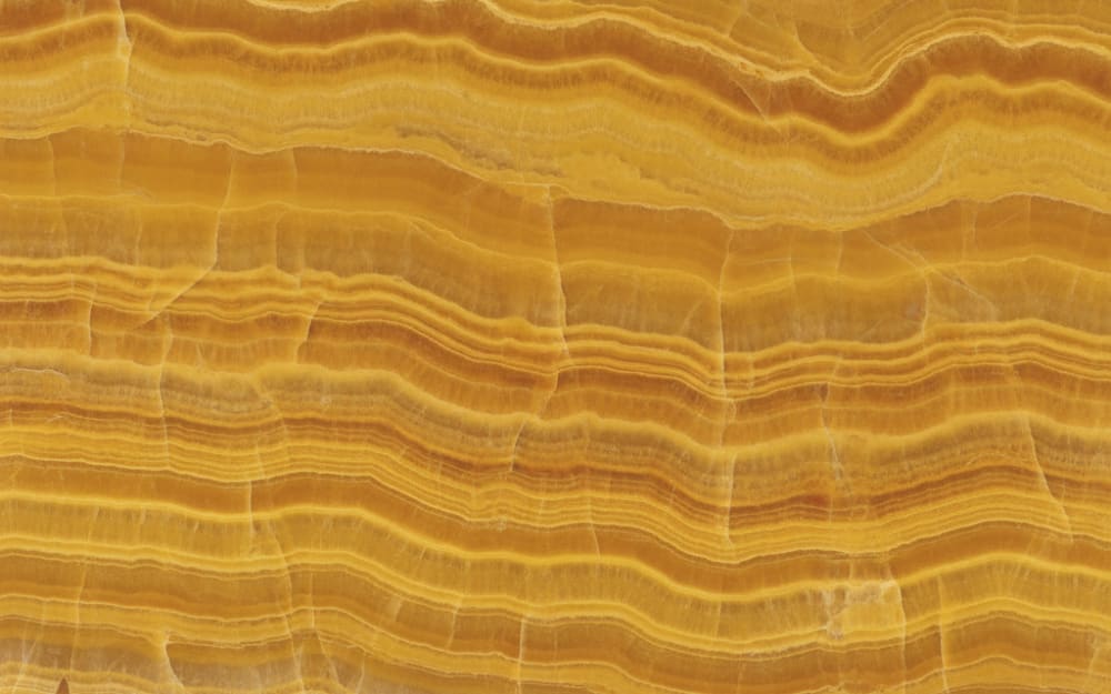 Honey Onyx onyx — polished slab surface showing Gold/Yellow coloring. Origin: Turkey (Afyon). Hardness: 3 Mohs. Acid sensitivity: high.