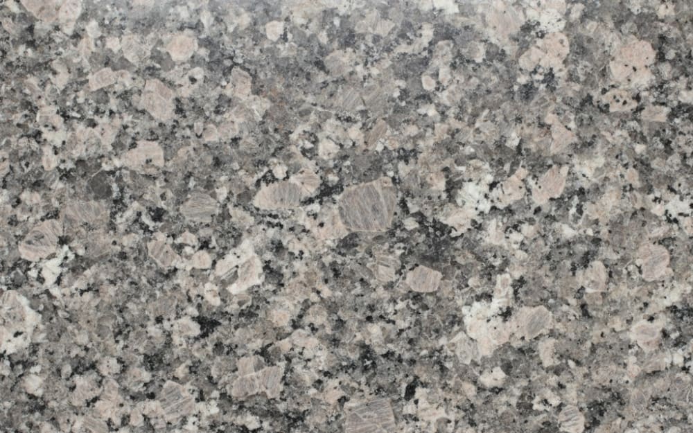 Imperial Bordeaux granite — polished slab surface showing Brown coloring. Origin: Brazil. Hardness: 6 Mohs. Acid sensitivity: none.