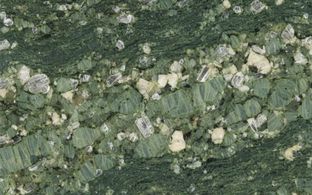 Kuppam Green granite — polished slab surface showing Green coloring. Origin: India (Andhra Pradesh). Hardness: 6 Mohs. Acid sensitivity: none.