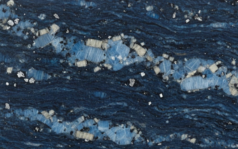 Labrador Blue Pearl granite — polished slab surface showing Blue coloring. Origin: Norway. Hardness: 6 Mohs. Acid sensitivity: none.