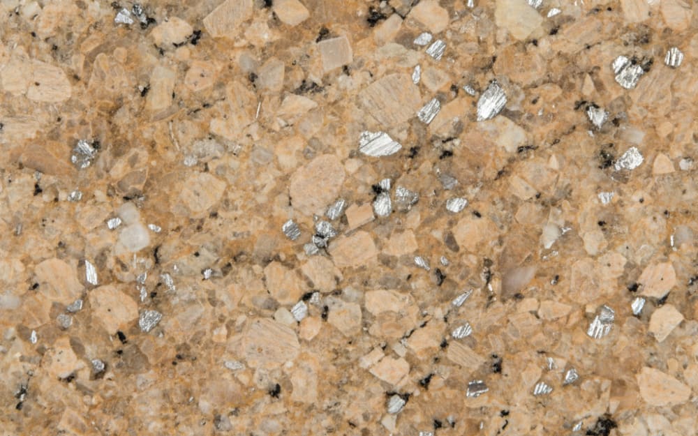Leathered Titanium granite — polished slab surface showing Tan/Beige coloring. Origin: Brazil. Hardness: 6 Mohs. Acid sensitivity: none.