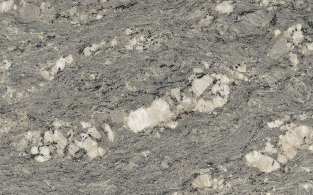 Lennon granite — polished slab surface showing Grey coloring. Origin: Brazil. Hardness: 6 Mohs. Acid sensitivity: none.