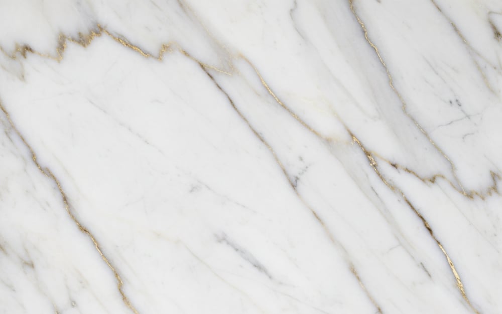 Mandala Classic marble — polished slab surface showing White coloring. Origin: Brazil. Hardness: 3 Mohs. Acid sensitivity: high.