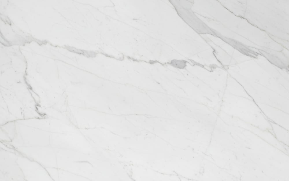 Montclair White marble — polished slab surface showing White coloring. Origin: USA (Vermont). Hardness: 3 Mohs. Acid sensitivity: high.