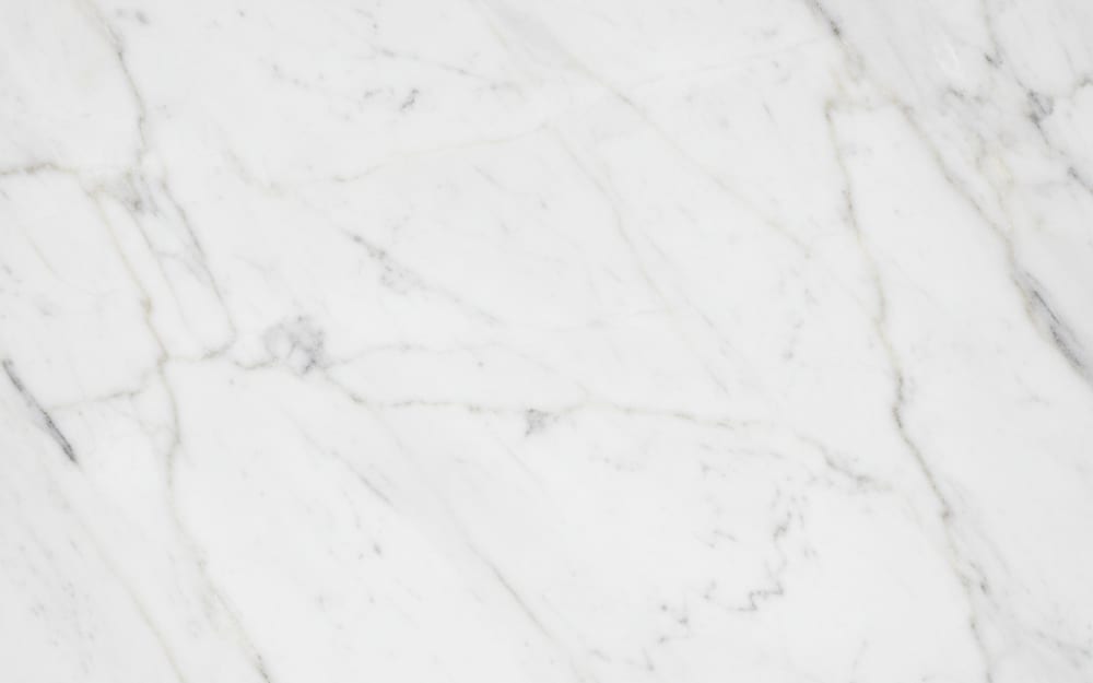 Mugla White marble — polished slab surface showing White coloring. Origin: Turkey (Mugla). Hardness: 3 Mohs. Acid sensitivity: high.